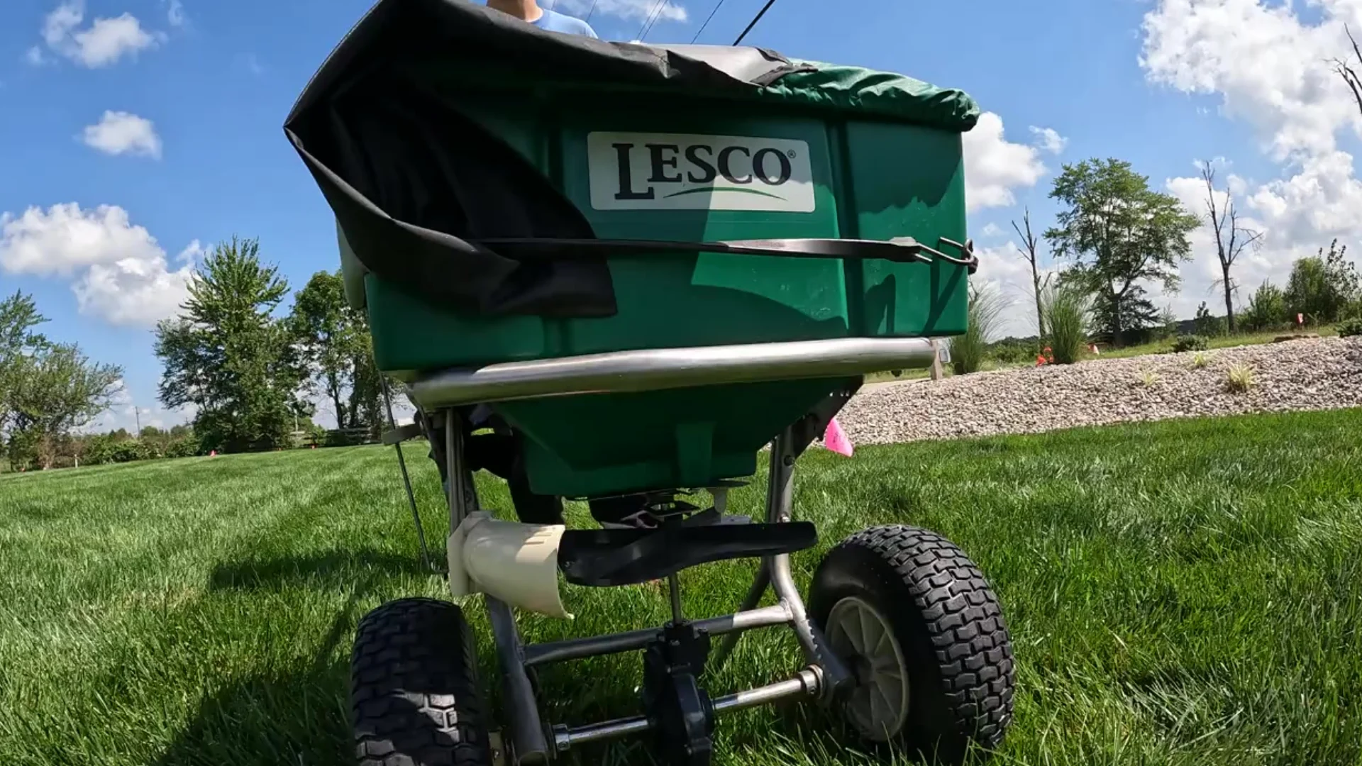Matt's Turf technician applying lawn fertilizer with professional equipment